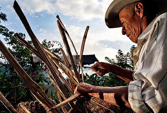 photograph of a man designing a basket as he weaves